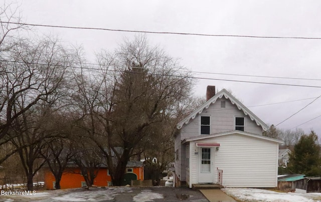 view of front of house featuring a chimney