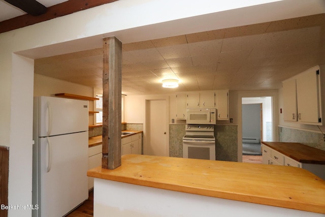 kitchen featuring white appliances, white cabinets, and butcher block counters