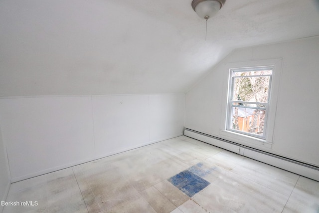 bonus room with baseboard heating and vaulted ceiling