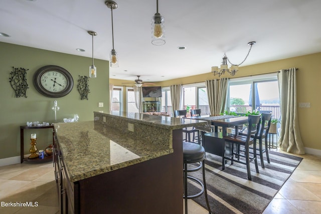 140 Hancock Rd, Pittsfield, MA 01201 - kitchen with light tile patterned flooring, baseboards, a kitchen breakfast bar, hanging light fixtures, and recessed lighting