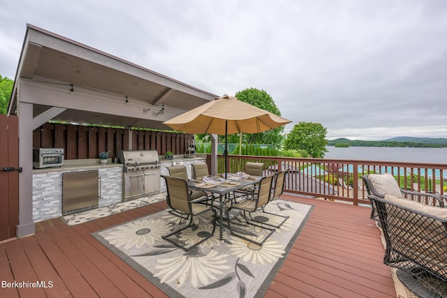 140 Hancock Rd, Pittsfield, MA 01201 - wooden terrace with outdoor dining area and a water view