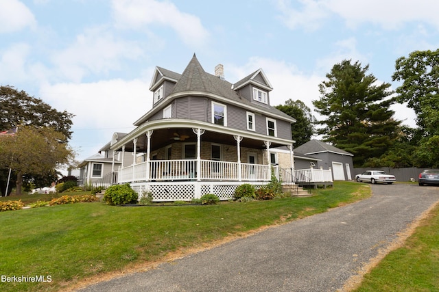 victorian-style house with a porch and a front lawn