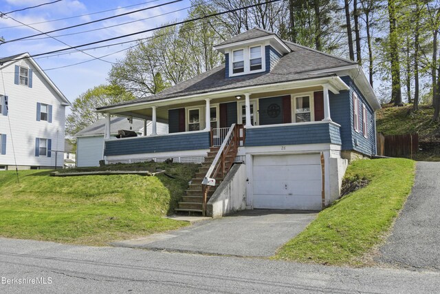 view of front facade featuring an attached garage, aphalt driveway, a porch, roof with shingles, and stairs