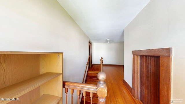 hallway featuring baseboards and wood finished floors