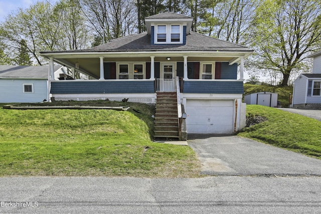 view of front facade featuring covered porch, a garage, a shed, stairway, and a front lawn