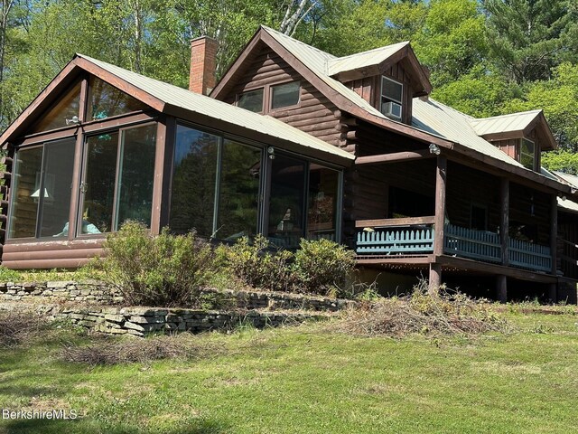 76 Corashire Rd, New Marlborough, MA 01230 - rear view of house featuring a sunroom, a chimney, log siding, and a lawn