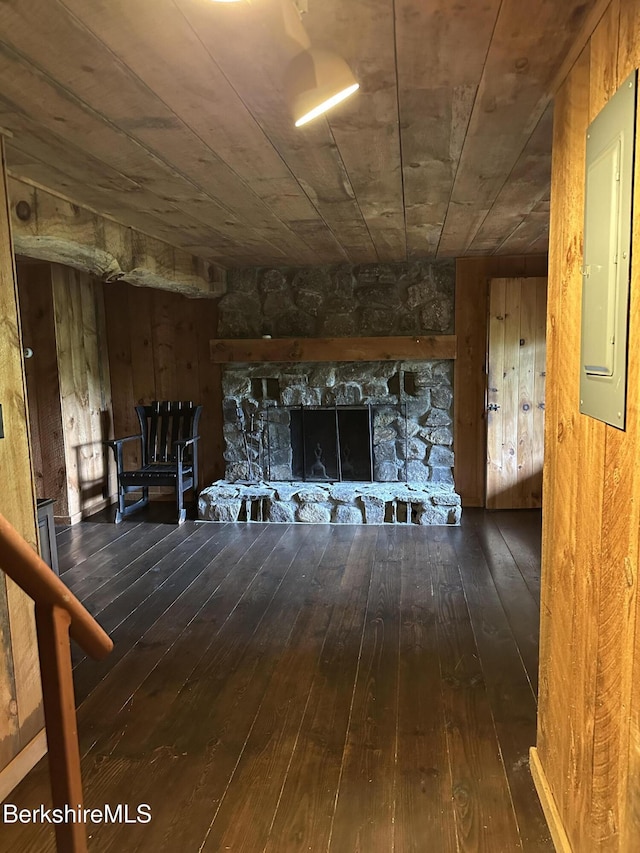 76 Corashire Rd, New Marlborough, MA 01230 - unfurnished living room with wood-type flooring, electric panel, a stone fireplace, and wooden walls