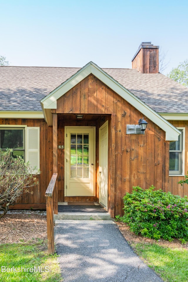 37 Corey Rd Unit 85, Hancock, MA 01237 - entrance to property featuring a shingled roof, a chimney, and board and batten siding