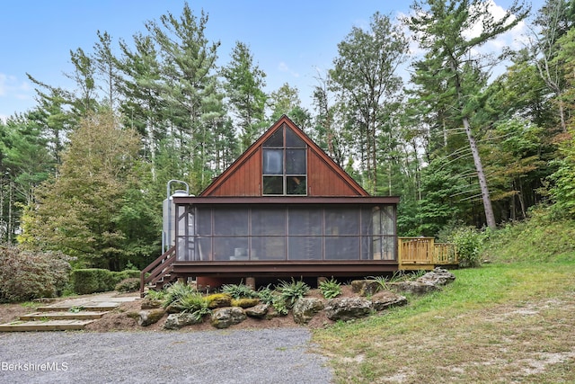 back of house with a sunroom