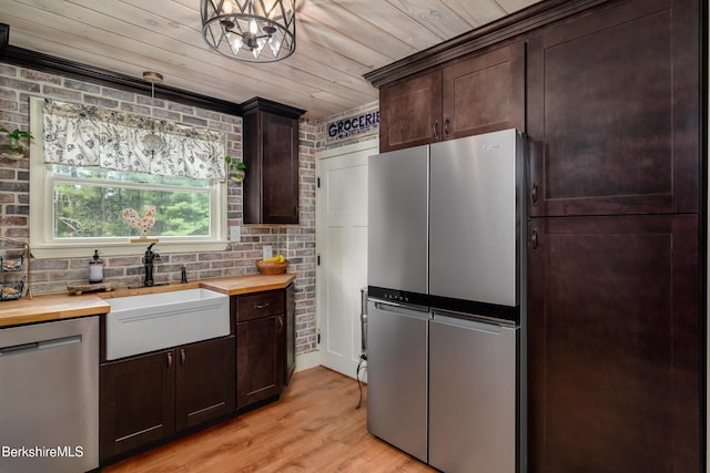 59 Orchard Rd, Dalton, MA 01226 - kitchen featuring butcher block countertops, stainless steel appliances, dark brown cabinets, light wood finished floors, and crown molding