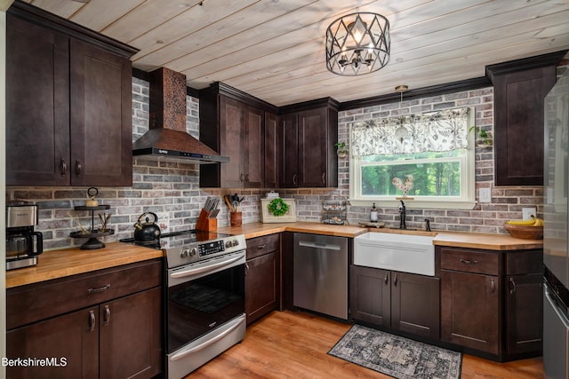 59 Orchard Rd, Dalton, MA 01226 - kitchen featuring stainless steel appliances, butcher block counters, wall chimney exhaust hood, wooden ceiling, and dark brown cabinetry