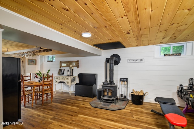 59 Orchard Rd, Dalton, MA 01226 - living area featuring a wood stove, wooden ceiling, plenty of natural light, wood finished floors, and concrete block wall