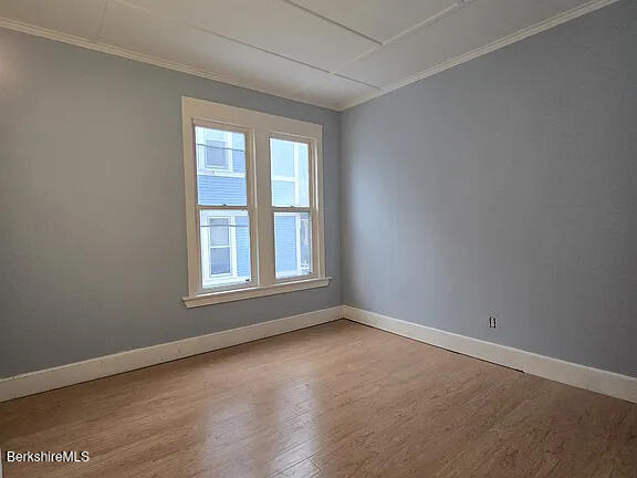 51 Bracewell Ave, North Adams, MA 01247 - spare room with wood finished floors and crown molding