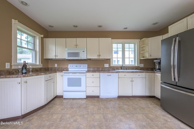 16 Revere Pkwy, Pittsfield, MA 01201 - kitchen with white appliances, plenty of natural light, open shelves, white cabinets, and recessed lighting