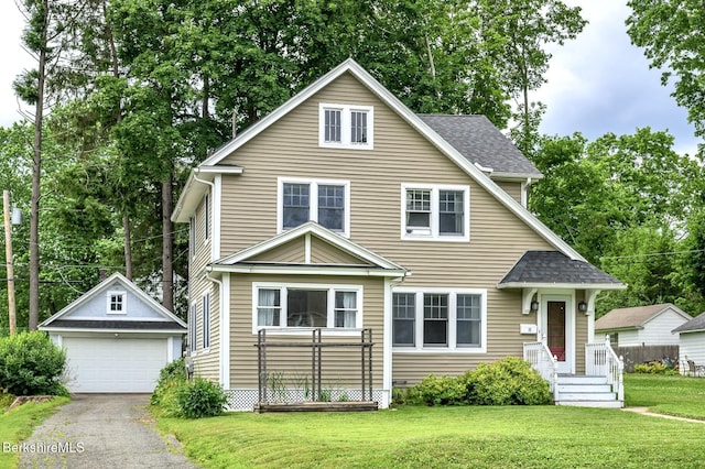 16 Revere Pkwy, Pittsfield, MA 01201 - view of front of house featuring an outdoor structure, a detached garage, a front lawn, and a shingled roof