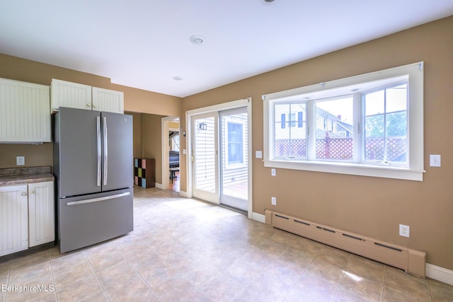 16 Revere Pkwy, Pittsfield, MA 01201 - kitchen featuring freestanding refrigerator, a baseboard heating unit, and white cabinetry