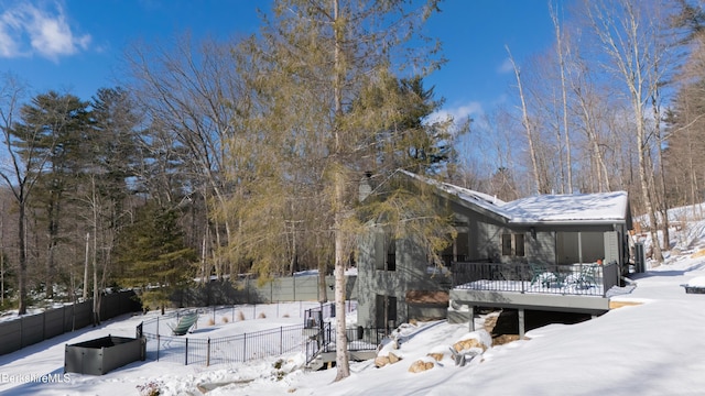 snow covered property featuring fence