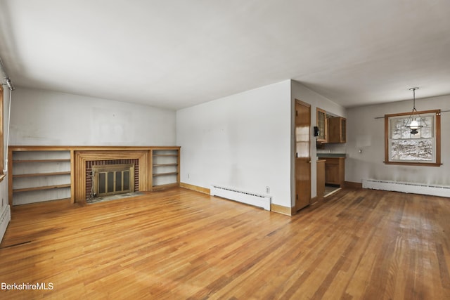 unfurnished living room featuring light wood-type flooring, a brick fireplace, and baseboard heating