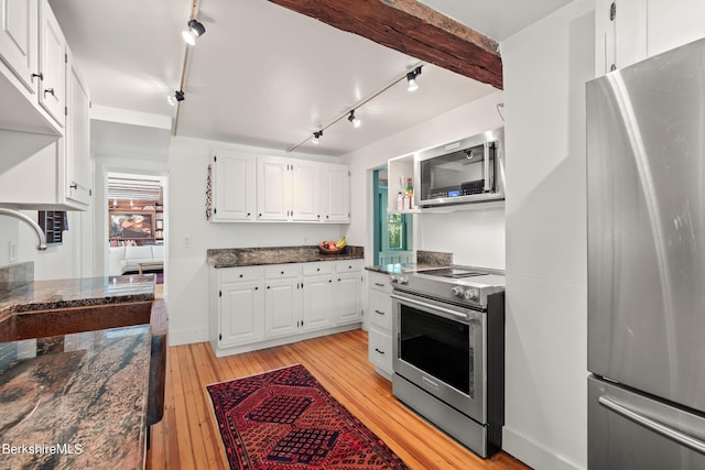 kitchen featuring stainless steel appliances, a wealth of natural light, white cabinets, and light wood-type flooring