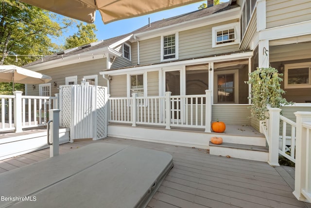 back of property featuring a wooden deck