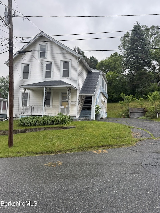 9 Anthony St, Adams, MA 01220 - view of front of home with covered porch, a front lawn, and roof with shingles