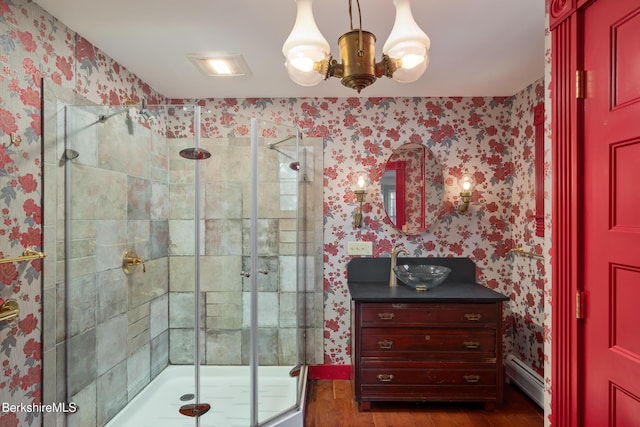41 Bulkley St, Williamstown, MA 01267 - full bath with wallpapered walls, wood finished floors, a shower stall, and a baseboard radiator