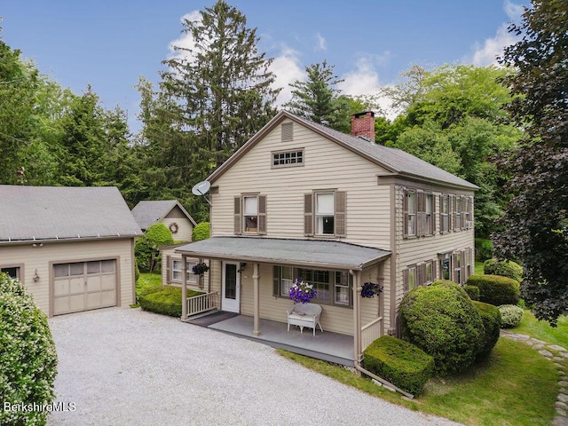 70 Main St, Egremont, MA 01258 - view of front of house featuring covered porch, a chimney, a garage, an outdoor structure, and driveway