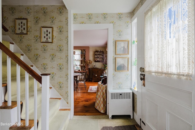 70 Main St, Egremont, MA 01258 - entrance foyer with wallpapered walls, radiator heating unit, plenty of natural light, stairs, and light wood-style flooring