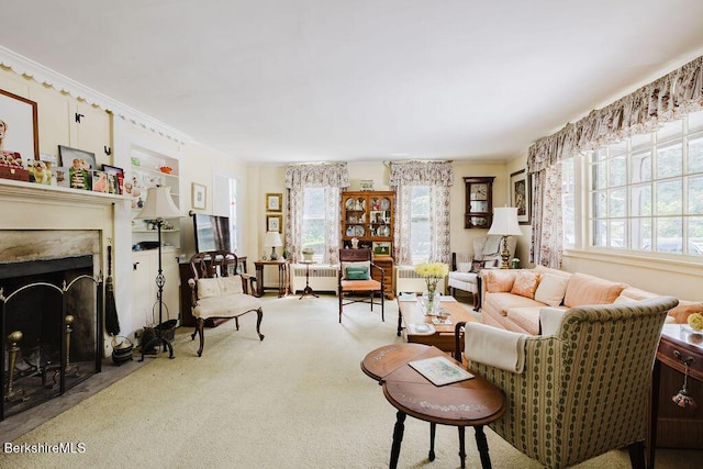 70 Main St, Egremont, MA 01258 - carpeted living room with plenty of natural light, a fireplace with flush hearth, and radiator heating unit