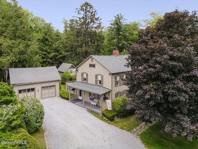 70 Main St, Egremont, MA 01258 - view of front of property featuring covered porch, an outbuilding, a chimney, a detached garage, and roof with shingles