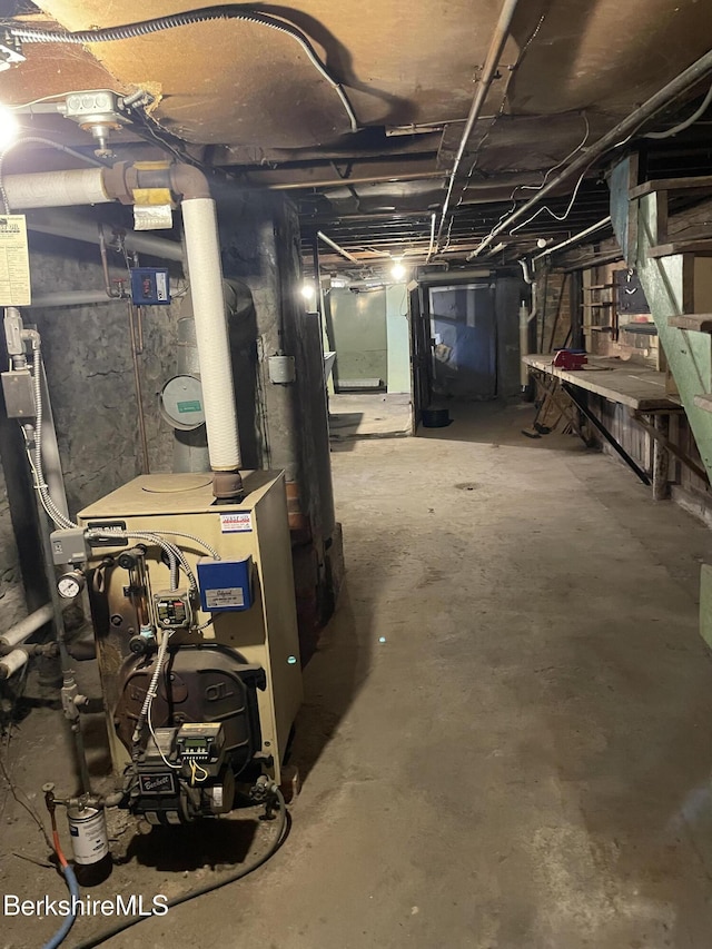 unfinished basement featuring a heating unit