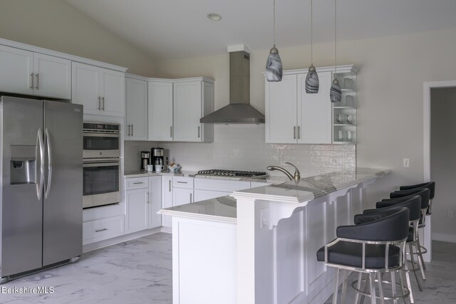 19 Aspen Way, Pittsfield, MA 01201 - kitchen featuring appliances with stainless steel finishes, wall chimney exhaust hood, a peninsula, backsplash, and a kitchen breakfast bar