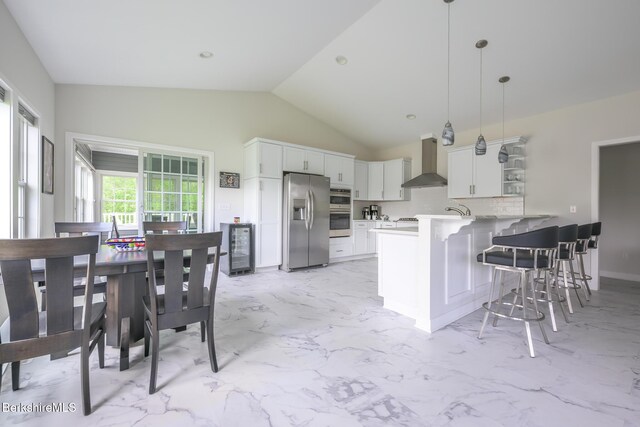 19 Aspen Way, Pittsfield, MA 01201 - kitchen featuring appliances with stainless steel finishes, wall chimney exhaust hood, a peninsula, wine cooler, and lofted ceiling