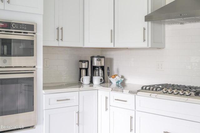 19 Aspen Way, Pittsfield, MA 01201 - kitchen featuring extractor fan, appliances with stainless steel finishes, tasteful backsplash, and white cabinets