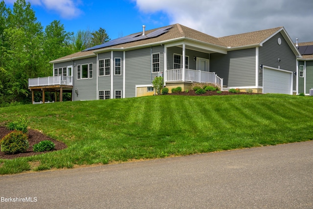 19 Aspen Way, Pittsfield, MA 01201 - view of side of property with covered porch, a garage, roof mounted solar panels, a lawn, and a shingled roof