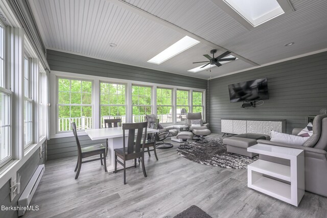19 Aspen Way, Pittsfield, MA 01201 - sunroom featuring a baseboard radiator, a skylight, a wooden deck, and plenty of natural light