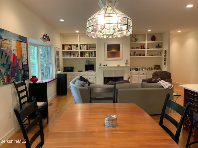 11 Prospect Hill Rd Unit 1, Stockbridge, MA 01262 - dining area with light wood-type flooring, recessed lighting, a fireplace, built in features, and a chandelier