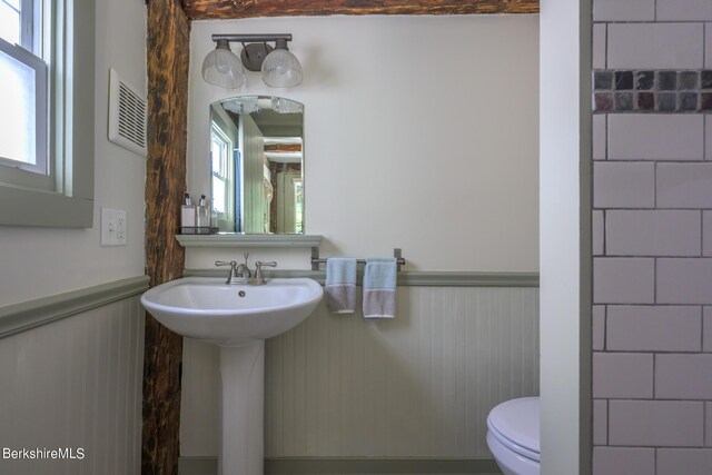 85 E Main St, Stockbridge, MA 01262 - half bath with wainscoting, toilet, plenty of natural light, and a sink