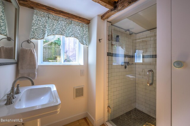 85 E Main St, Stockbridge, MA 01262 - bathroom with a stall shower, beamed ceiling, a sink, and baseboards