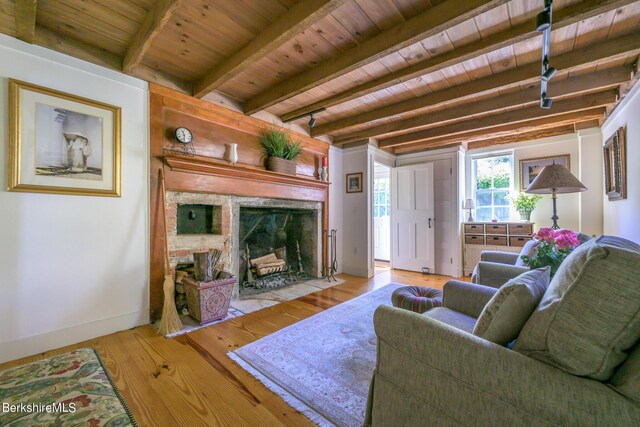 85 E Main St, Stockbridge, MA 01262 - living room featuring wooden ceiling with exposed beams, wood finished floors, a fireplace, and baseboards