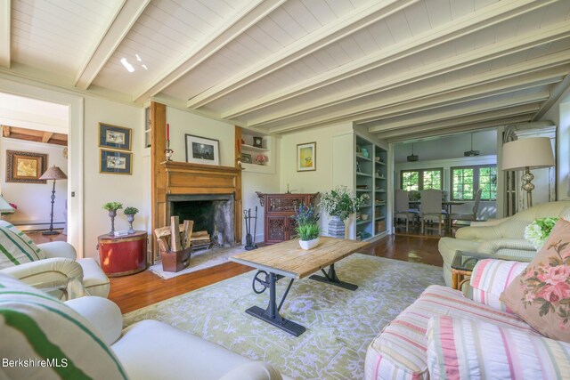 85 E Main St, Stockbridge, MA 01262 - living area with wood finished floors, beamed ceiling, a large fireplace, and built in features