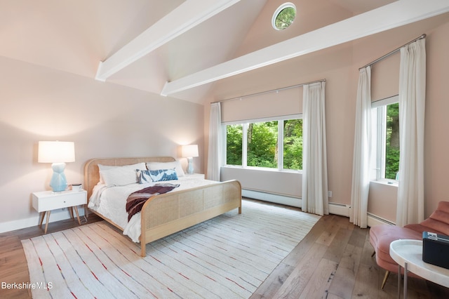 bedroom with high vaulted ceiling, a baseboard radiator, and hardwood / wood-style flooring