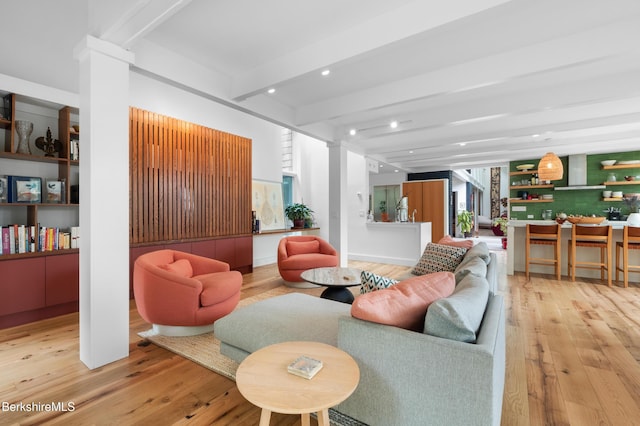 living room featuring beam ceiling, decorative columns, wood-type flooring, and recessed lighting