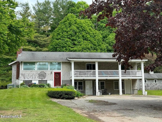 view of front of home with a front lawn and central air condition unit