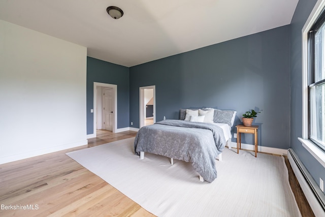 138 Ridge Rd, Worthington, MA 01098 - bedroom featuring a baseboard heating unit, multiple windows, and light wood-type flooring
