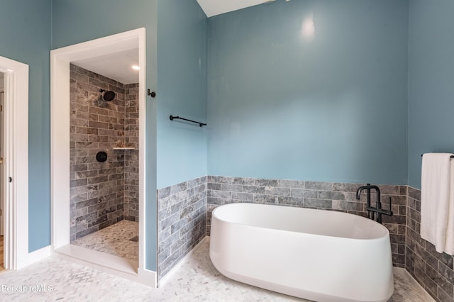 138 Ridge Rd, Worthington, MA 01098 - bathroom with a freestanding tub, tile walls, tiled shower, and wainscoting