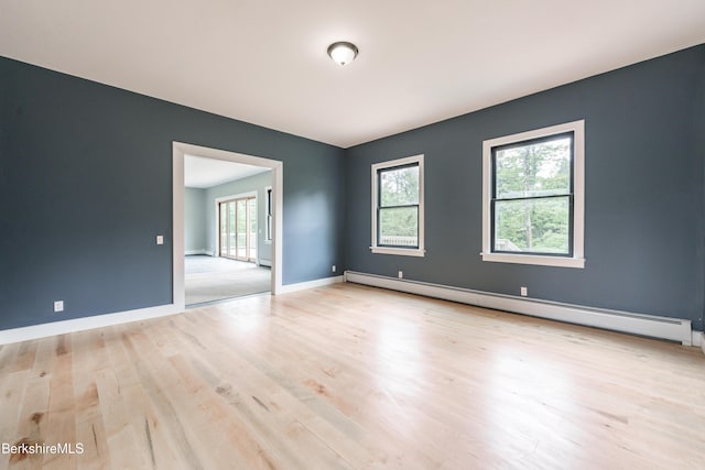 138 Ridge Rd, Worthington, MA 01098 - empty room with a baseboard heating unit, wood finished floors, and baseboard heating