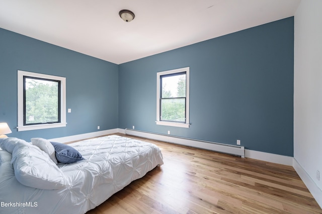 138 Ridge Rd, Worthington, MA 01098 - bedroom with a baseboard radiator and wood finished floors