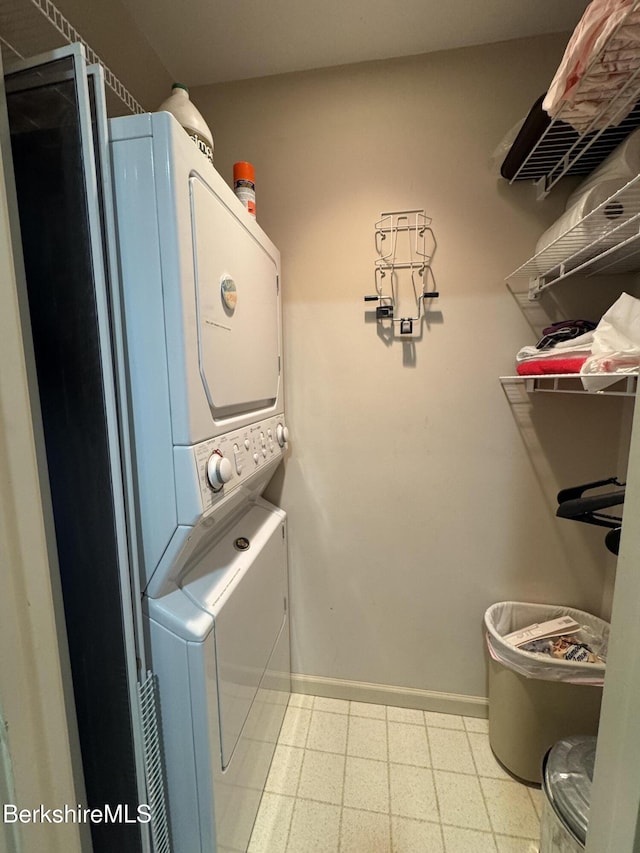 37 Corey Rd Unit 826, Hancock, MA 01237 - clothes washing area with light floors, baseboards, stacked washer and dryer, and laundry area