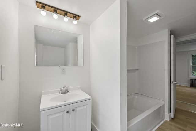 102 Pontoosuc Ave, Pittsfield, MA 01201 - bathroom featuring vanity, wood finished floors, and radiator heating unit